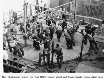 This photo shows the first NRU reactor vessel and lower header being raised This photo shows the first NRU reactor vessel and lower header being raised