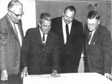 L-R: B.P. Scull, M.D. Berry, J.S. Foster, and I.L. Wilson shown at the Manby Center in March 1958.
<br /><br />
Photo source – AECL. 102-1000