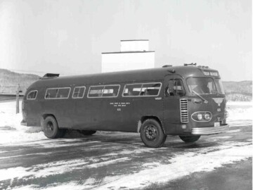 RCAF surplus buses. Shortly after the end of the war, a large number of RCAF buses become available and these replaced the tractor-trailer units used earlier. From the “History of Deep River” we learn; “These buses were 28 feet in length and had seven jump-seats in the aisle. Latecomers were issued boards by the driver and these were fitted between the regular seats and collected on arrival”. The use of the extra seats undoubtedly led to the CRNL method of exiting the buses at the Plant. This was always done in an orderly manner with passengers from the front row, right-hand seat, disembarking first followed by the ones across the aisle and then the second row, etc. Many a new employee who might have found a seat near the back of the bus would be embarrassed on their first trip by having stood up to march down the aisle before their turn.Photo source – AECL. 104-1000