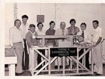 To meet the needs of therapists, Commercial Products began a program to develop accelerator-based cancer therapy units to compliment the cobalt-60 series of machines. The development team In Ottawa for units based on a 6 MeV linear accelerator is seen here. L.R: J. Beard, P. Castonguay, D. Smyth, D. Wilkinson, B. Moore(?), B. Sleigh, G. Malkowski, D. Molson and R. Murphy.<br /><br />Photo source – AECL. 108-1000