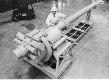 K.G. Wiega checks a full-scale wooden model of the fueling machine for the Pickering G.S. at the Sheridan Park development labs.
<br /><br />
Photo and caption source – AECL Review, March 1967. 111-1000