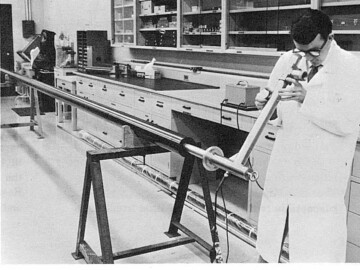 R. Wison uses a borescope to look for blemishes on the interior of a Pickering Zircaloy pressure tube.<br /><br />Photo and caption source – AECL Review, September 1968. 115-1000