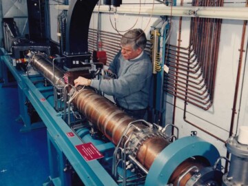 The IMPELA Prototype. D. Smyth is seen here making some measurements on the prototype unit in the concrete tunnel<br /><br />Photo source-AECL. 118-1000