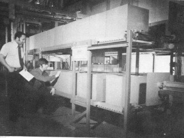 A high capacity irradiator used for biological sterilization of medical supplies undergoing final tests at Commercial Products. L-R. F. Fraser and R. Harrod.
<br /><br />
Photo source and caption– AECL Review, August 1973. 123-1000-1