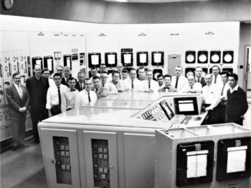 (L-R): W.B. Lewis, Gene Critoph, Jim Sheridan, Doug Griffin, Bob Lalor, Rupe Wright, Jim Aspinal, Gib James, Grant Childerhose, Norm Brown (back), Jim Mullen (front), John Inglis, (back), Doug MacCready (front), Murray Moore, Don Ross, Cliff Brown, John McNeil, ?, Ed Kerr, ?, Al Okazaki, Harry Collins, John Sproule, John Hilborn, Mel Berlie, Gorman Kay, Mani Masicotte, Gavin Nicholson. NRU Restart, 1964