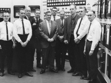 L-R: Grant Childerhose, Ed Kerr, Rupe Wright, John Hilborn, W.B. Lewis, John Inglis, Gib James, Gene Critoph, Harry Collins, John Sproule NRU Restart, March, 1964
