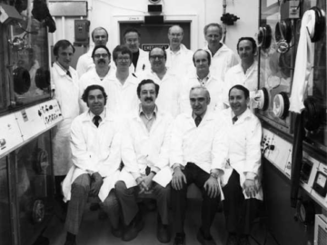 Back (L-R): Bruce Hildebrand, Les Shurrock, Ron Boucher, Floyd Miller Middle: Jim Cairns, Jim Conversi, Allan Zeller, Don Shade, Len Norlock, Ron Stack Front: Allan Jeffs, Mighaile Audaro (Argentina), Ross McEwan, Alan Ross Bldg. 375 Plutonium Lab., April, 1977