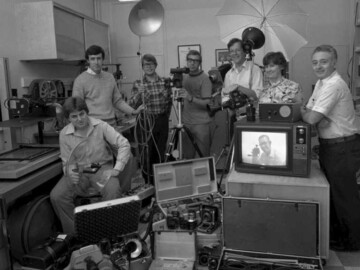 (L-R) : Dennis Corrigan, Ken Gauthier, Ralph Robinson, Frank Yuke, Mike Brown, Louise Milani, Doug Brown. The image of Cliff Baskin (Group Leader), who took the photo, appears on the television monitor. CRNL Photography, August, 1980